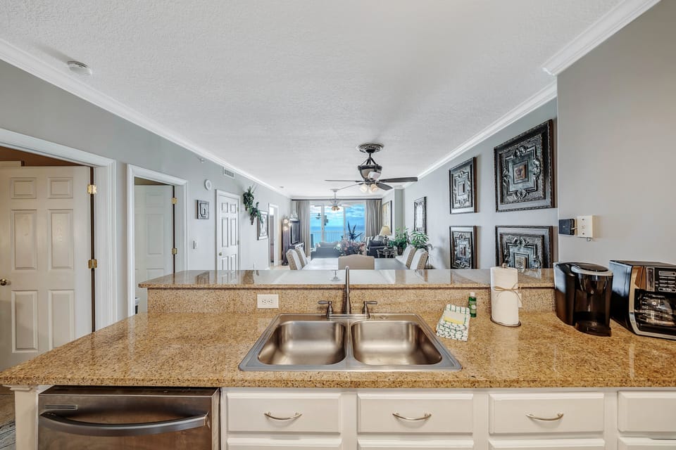 The fully equipped kitchen features granite countertops and stainless-steel appliances.