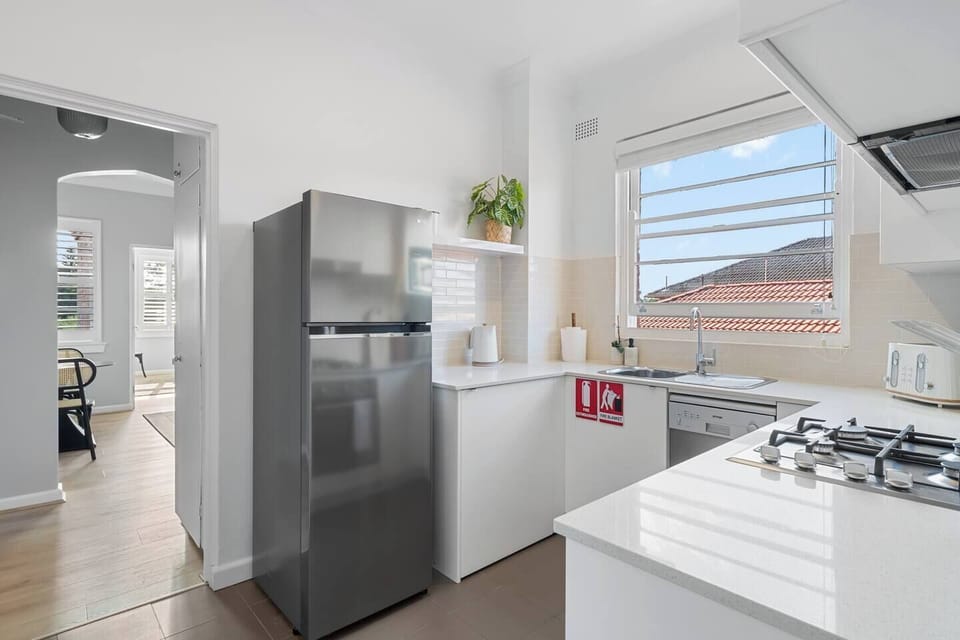 The modern kitchen has all the essentials needed to prepare meals at home, plus a dishwasher for easy clean-up.
