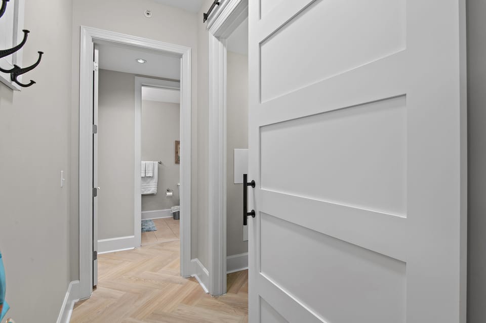 Hallway leading to laundry room with barn doors and to the 2nd King Bedroom.