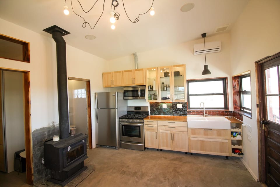 wood burning stove in living space, open kitchen design