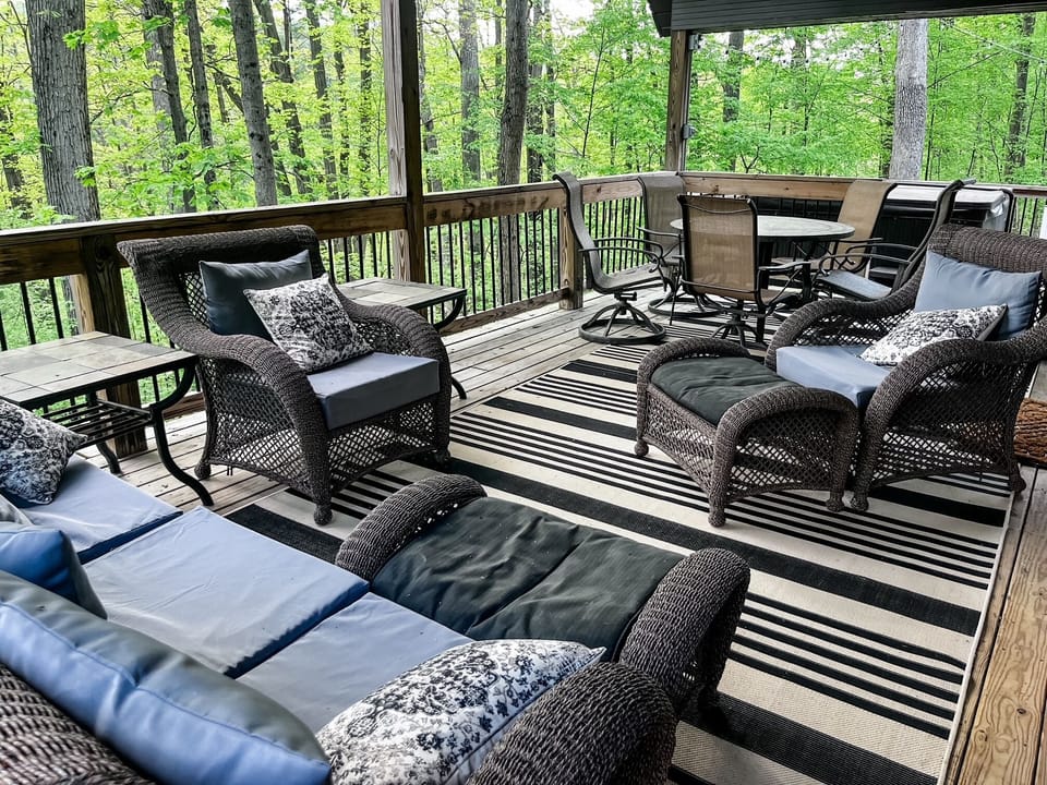 The covered outdoor living space offers plenty of spots to relax and chill as well as a table and chairs for outdoor meals!