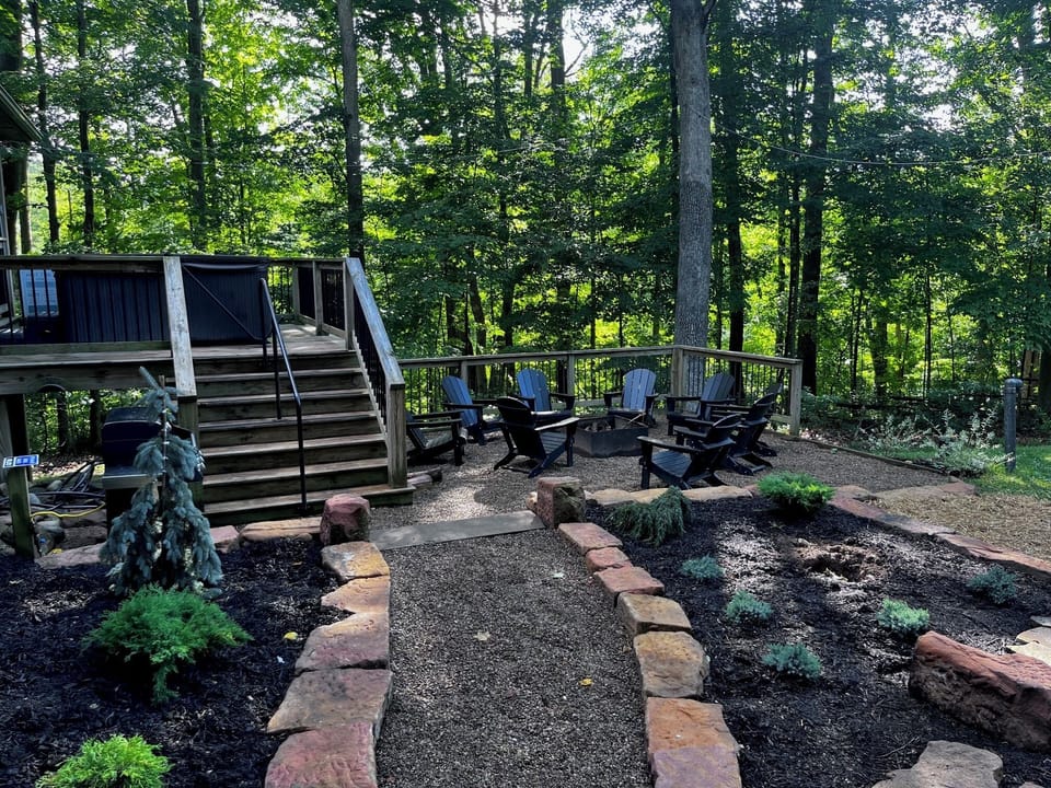 The peaceful outdoor setting at Pine Lane cannot be beat! Surrounded by woods Pine Lane offers a fire pit, lawn for playing, gas grill, hot tub, and covered porch/living area,