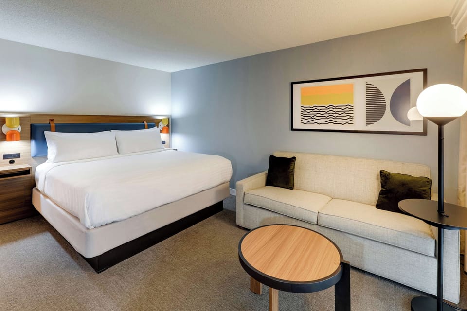 Unwind on plush linens beside a cozy sofa retreat.