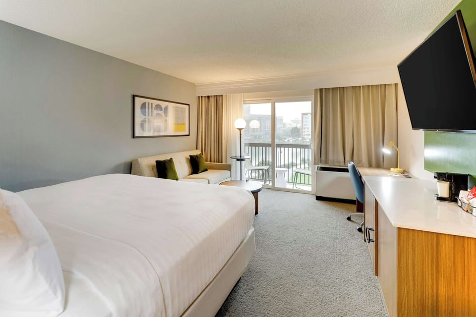 Linger in comfort with a sofa lounge beside crisp bedding.