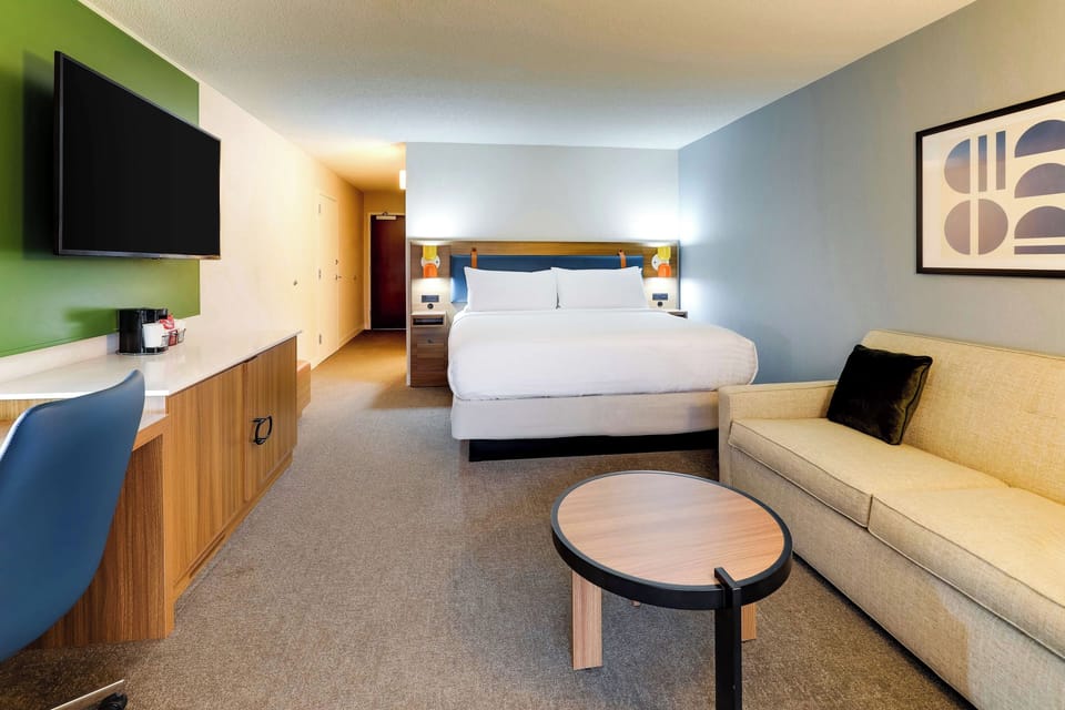 Relax in a spacious studio layout with sofa and TV.