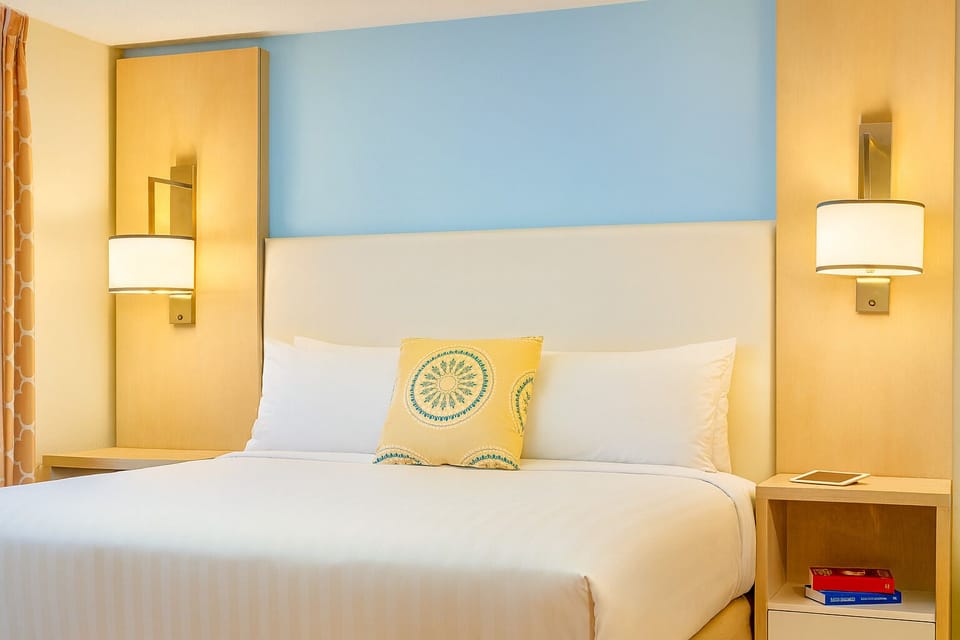 Unwind into crisp linens and warm, hotel-style lighting.