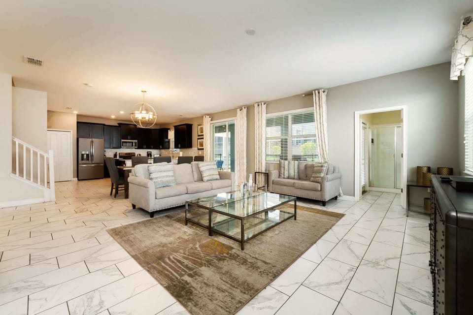Spacious open-plan living area with modern kitchen, perfect for family gatherings and relaxation.