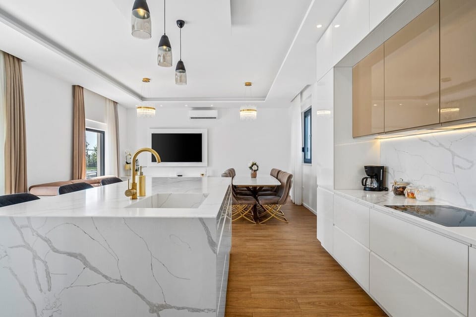 Fully equipped kitchen with dining and living room, and exit to pool area 