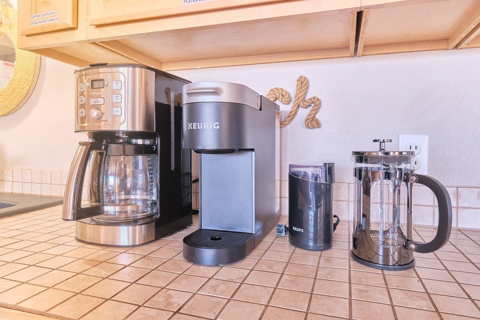 Start your day with a fresh brew from our coffee bar, complete with a coffee maker, single-cup Keurig, coffee grinder, and French press.