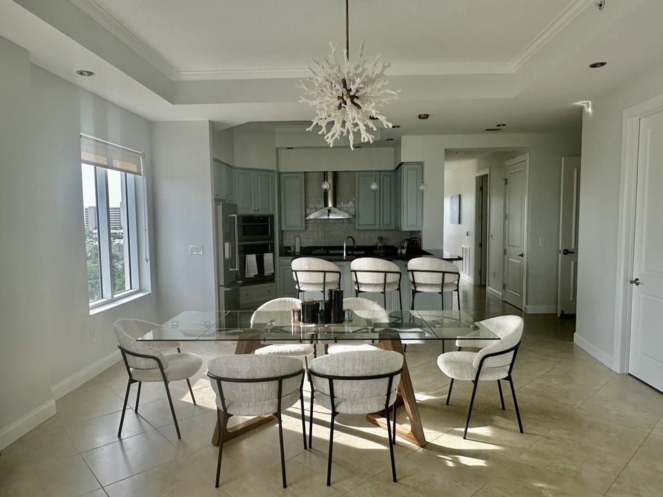Modern dining next to open kitchen.