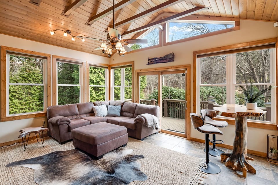 Step into our sunroom, a bright and inviting space that boasts a 55" Smart TV.