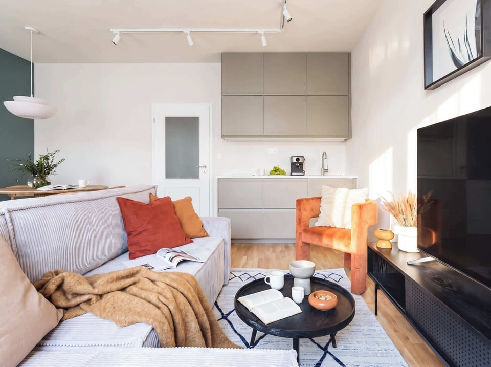 Living room with TV with Netflix and kitchen