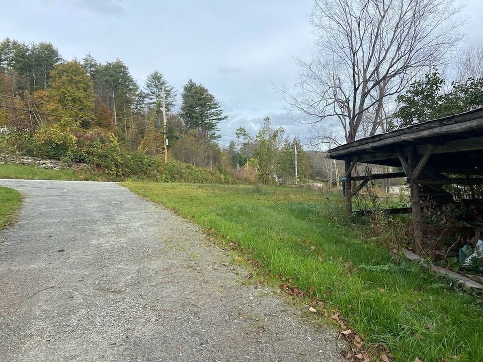 View from the front driveway. Classic Vermont charm meets modern comfort — your perfect base for family trips, ski weekends, and nature getaways. 