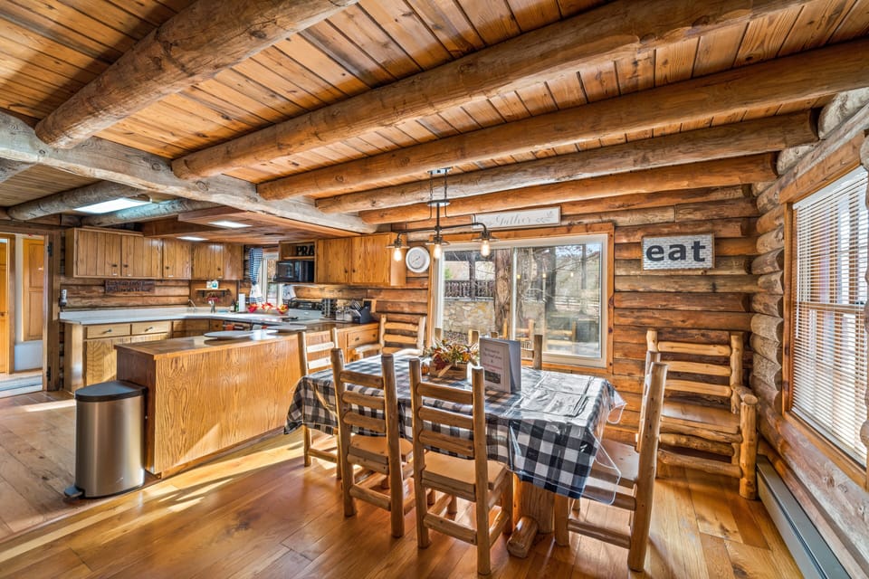 Dining room with log table and chairs.