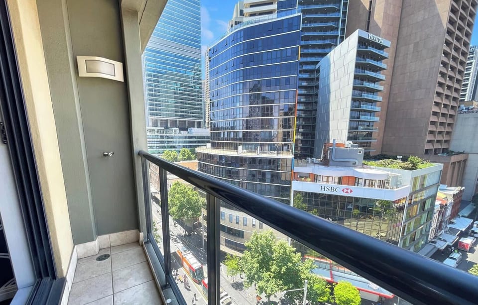 Balcony view overlooking the city streets and light rail below.