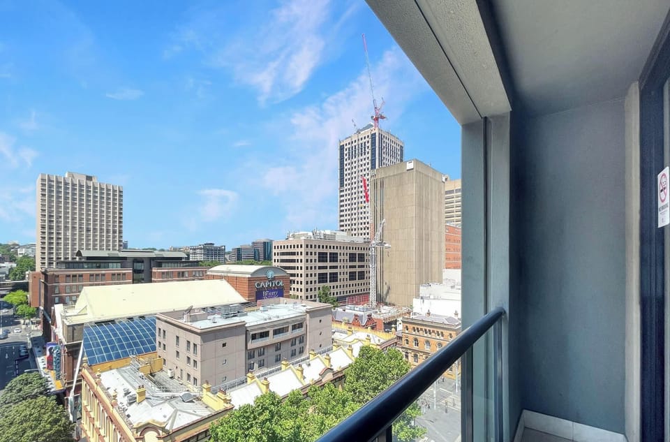 Balcony view towards Capital Theatre and surrounding city buildings.