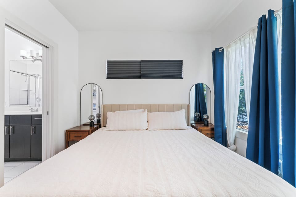 King size bed with walk in shower. Also, the room has a desk and chair.
