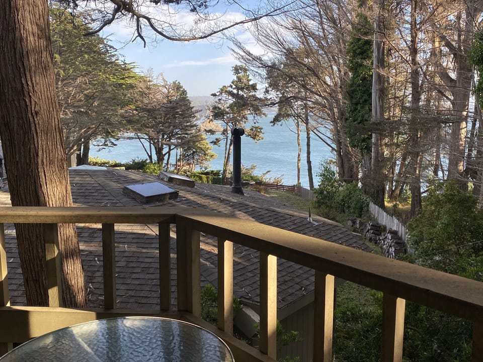 Your private balcony with table & chairs &  a roof-top view of the Pacific Ocean