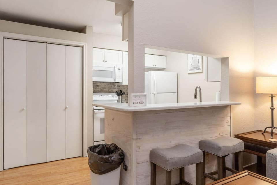 Your fully equipped kitchen features modern appliances and a breakfast bar where you can enjoy morning coffee and plan adventures.