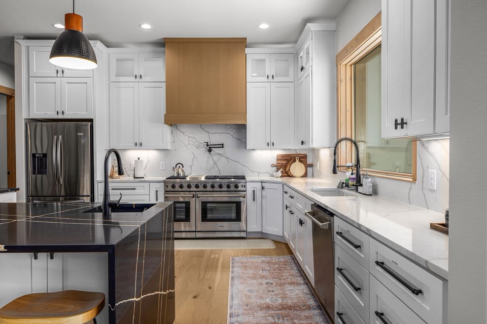 Designer stocked kitchen with Commercial range, two sinks, and wine fridge