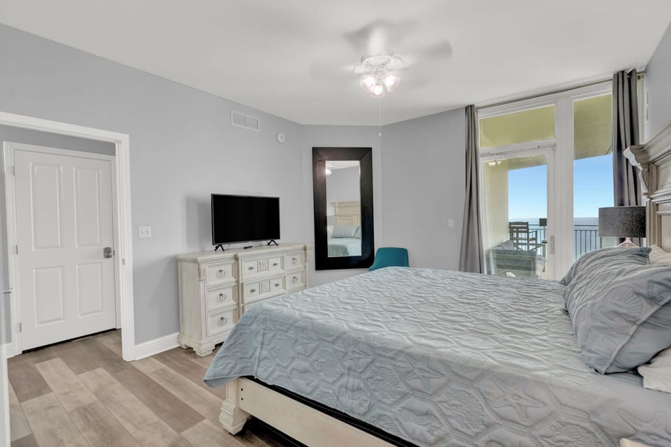 The master bedroom is spacious and tastefully decorated with a King bed, balcony access with Gulf Views, closet, Smart TV, and large bathroom with dual vanity and WALK-IN shower!