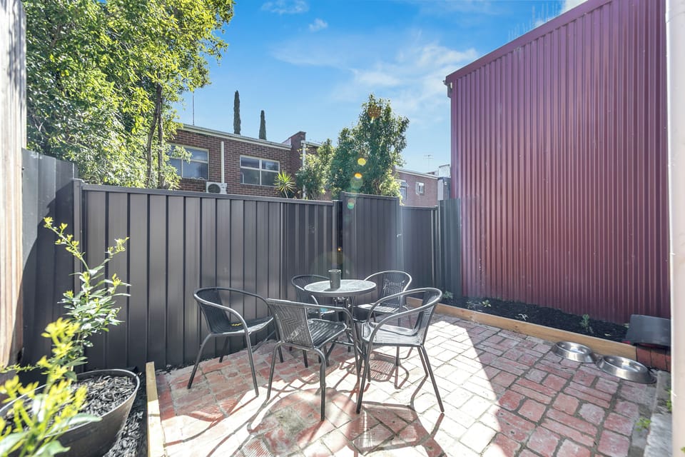 Sunny private courtyard with outdoor seating for coffee or alfresco dining