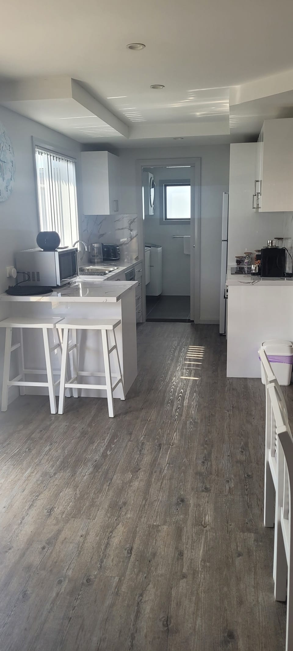 FULLY EQUIPPED KITCHEN , LOOKING INTO THE BATHROOM/LAUNDRY.