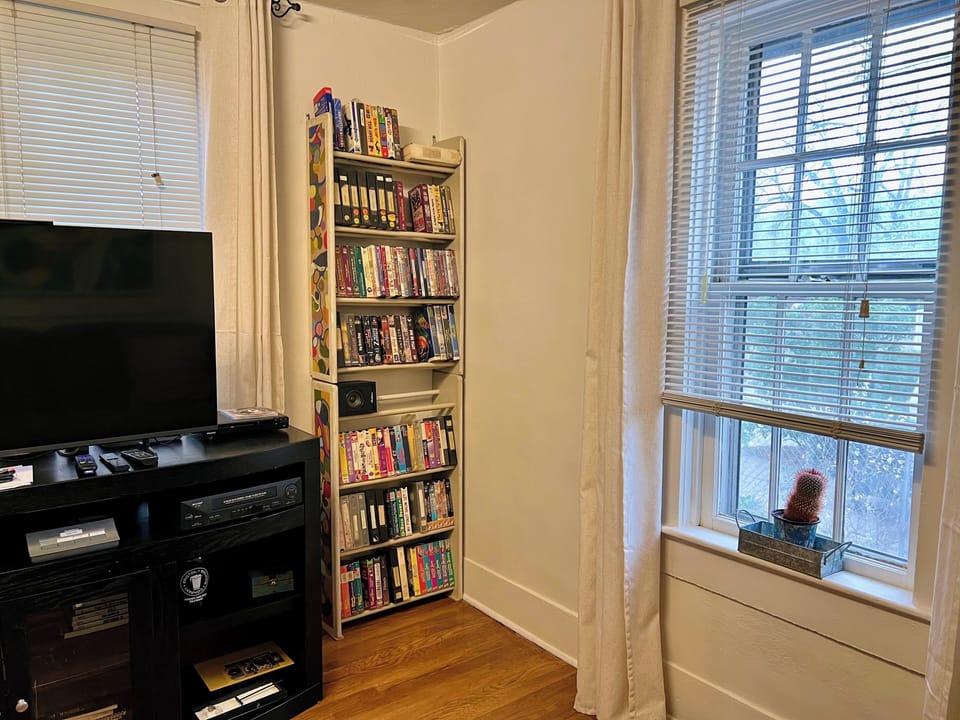 There are DVDs and tapes to watch, some books, a record player and some records.