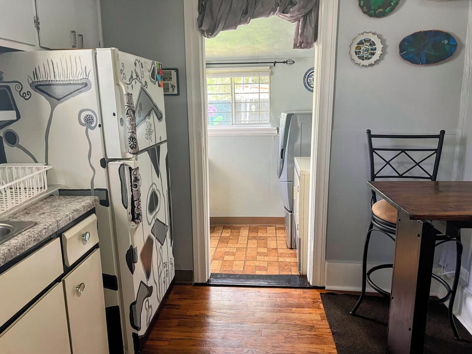 Kitchen looking at the laundry area and the backyard.