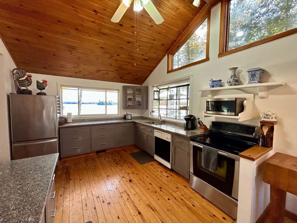 Large kitchen with granite counters and water system. Sit down island area for 3