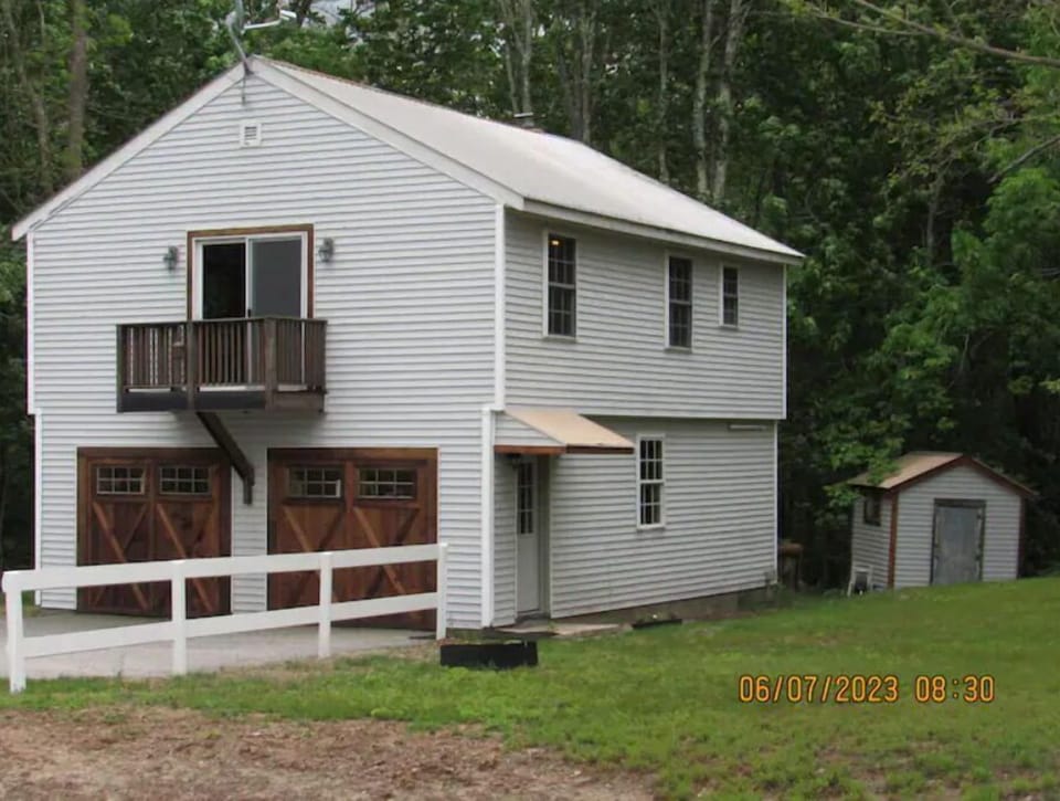 The carriage house an outside view has a large yard.