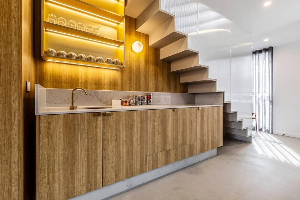 A dedicated wet bar adds another level of sophistication to the property, fully stocked for cocktail mixing.