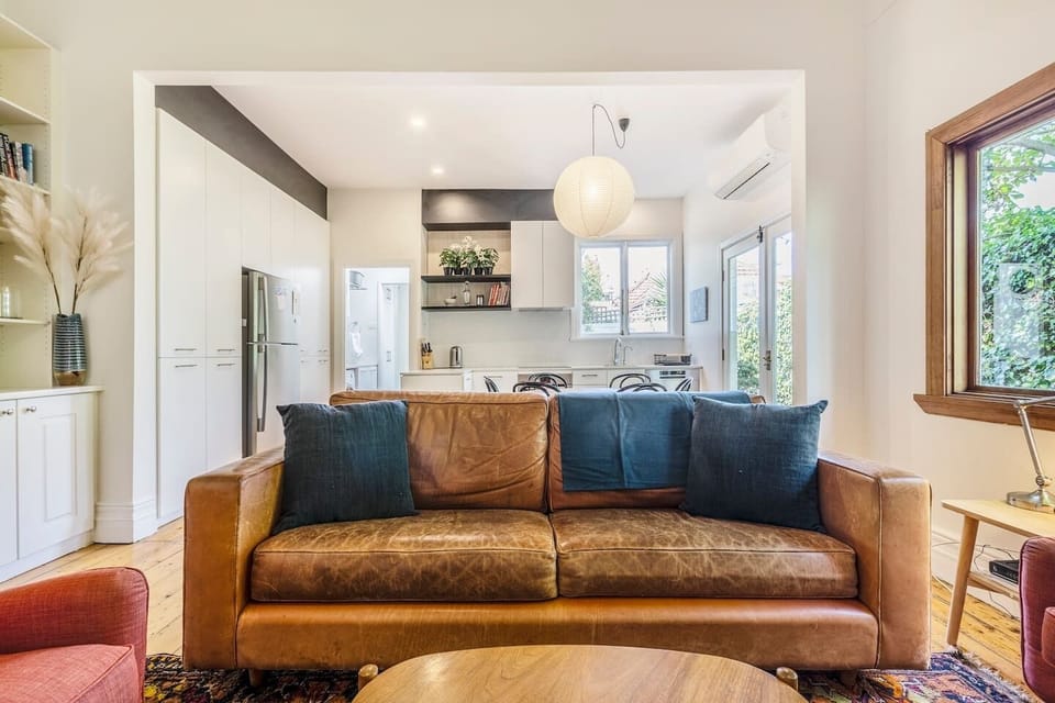 The light-filled living area offers a cosy sofa and armchairs where you can settle in with a book or relax with your favourite Netflix series.