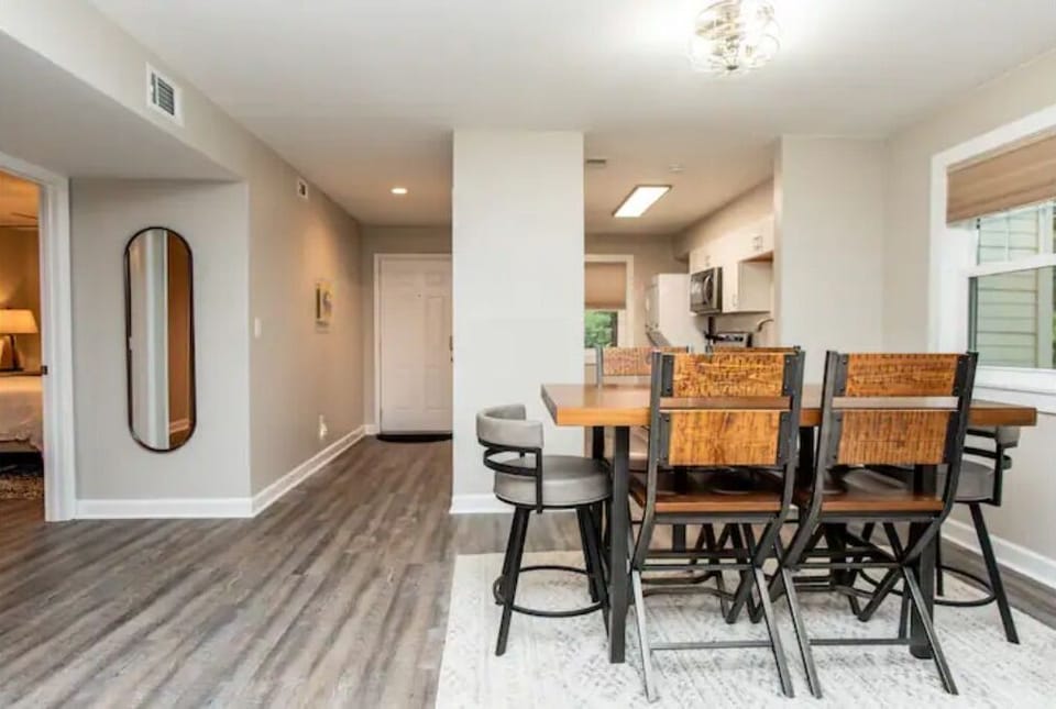 Front door entry leads into the open dining area with seating for six.