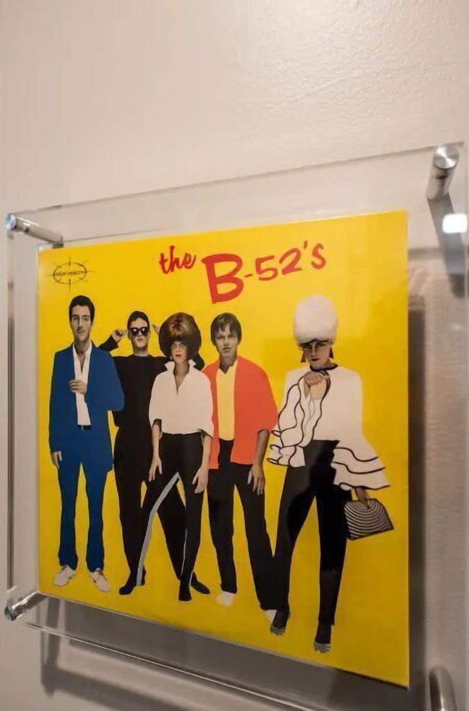 Hanging framed album covers of the local homegrown bands throughout the unit.