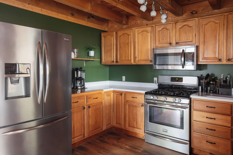 Rustic full kitchen with stainless appliances and cozy wood details