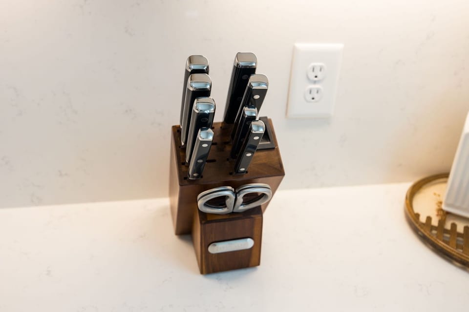 (1st Floor) Fully-equipped kitchen with stainless steel appliances, basic cooking essentials, and kitchen island seating.