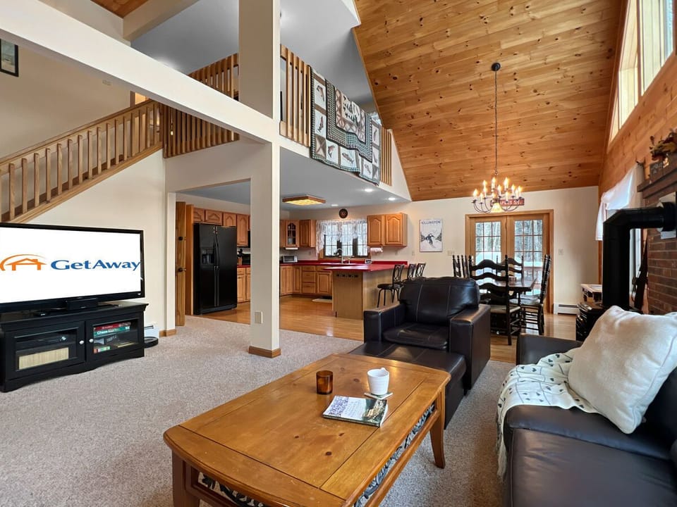 Living room with plenty of seating and natural lighting.