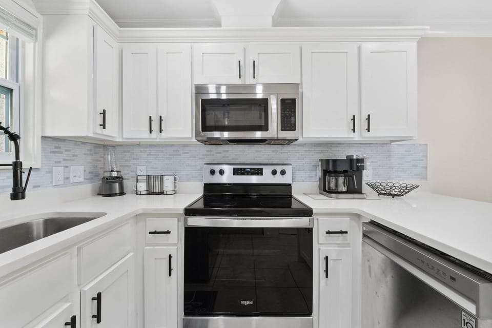 Modern kitchen with stainless steel appliances and white cabinetry