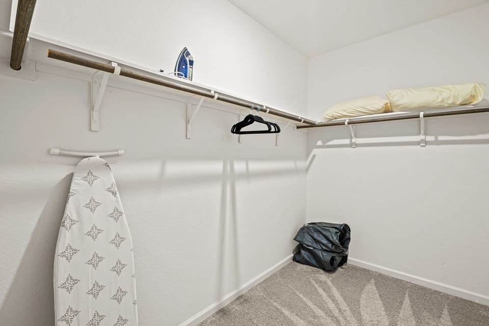 Walk-in closet with hanging and storage space makes unpacking easy during longer stays. A valuable feature for relocating families, construction professionals, corporate travelers and insurance housing guests needing extended accommodations in Lavon.