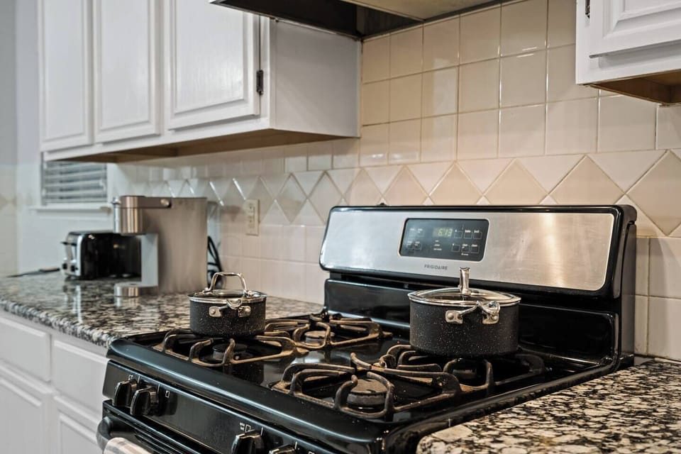 Fully equipped kitchen with a gas stove, ideal for cooking meals during your stay. After stocking up at nearby Walmart or Sprouts, enjoy preparing meals in this well-equipped space for long-term insurance stays.