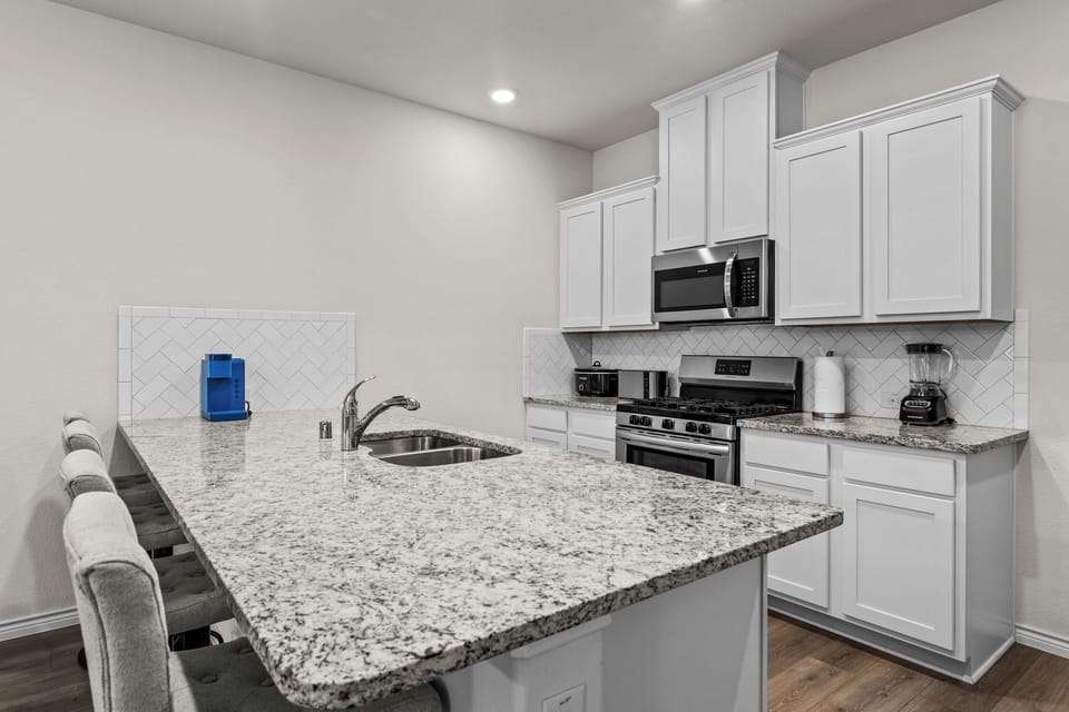 Granite countertops and stocked kitchen essentials for crews avoiding hotel dining costs.