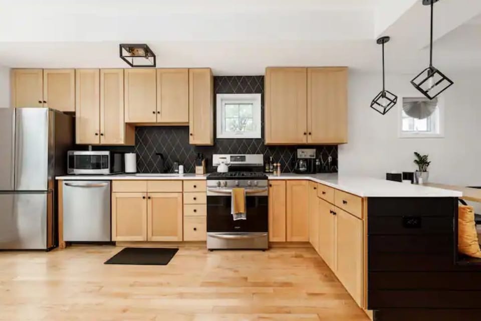 Fully stocked kitchen with fridge, dishwasher, oven, stove, microwave