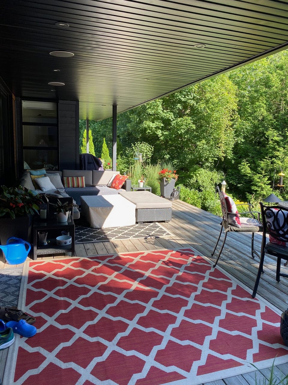 Covered back deck overlooking garden and forest