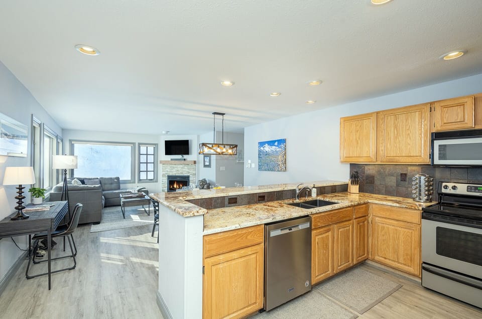 Designed for both functionality and entertaining, this spacious kitchen includes bar seating and a dedicated dining area.