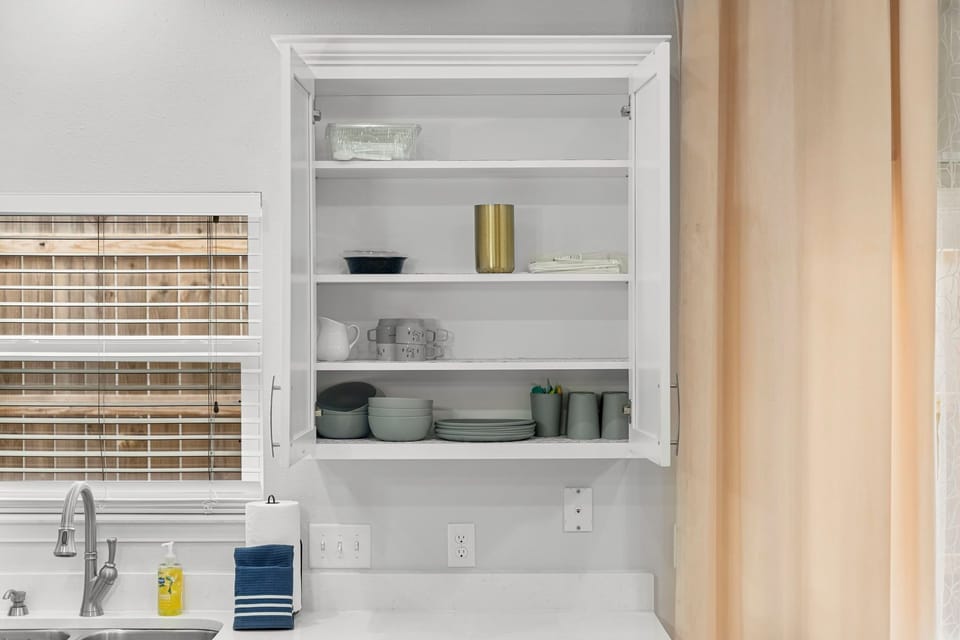 A fully stocked kitchen with plenty of glassware, bar essentials & appliances.