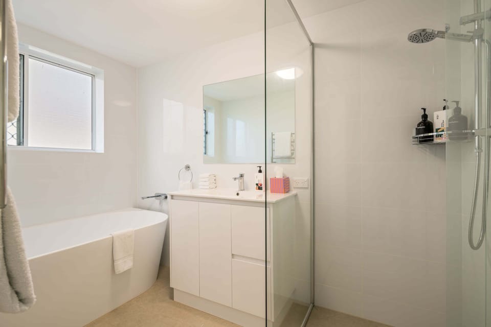 The main bathroom is complete with a shower, bath and vanity.