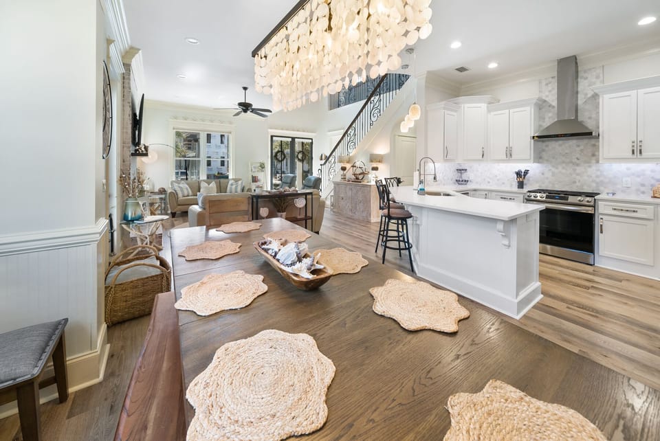 Your gourmet kitchen flows into elegant living areas, where you'll gather under stunning chandeliers and enjoy modern comfort.