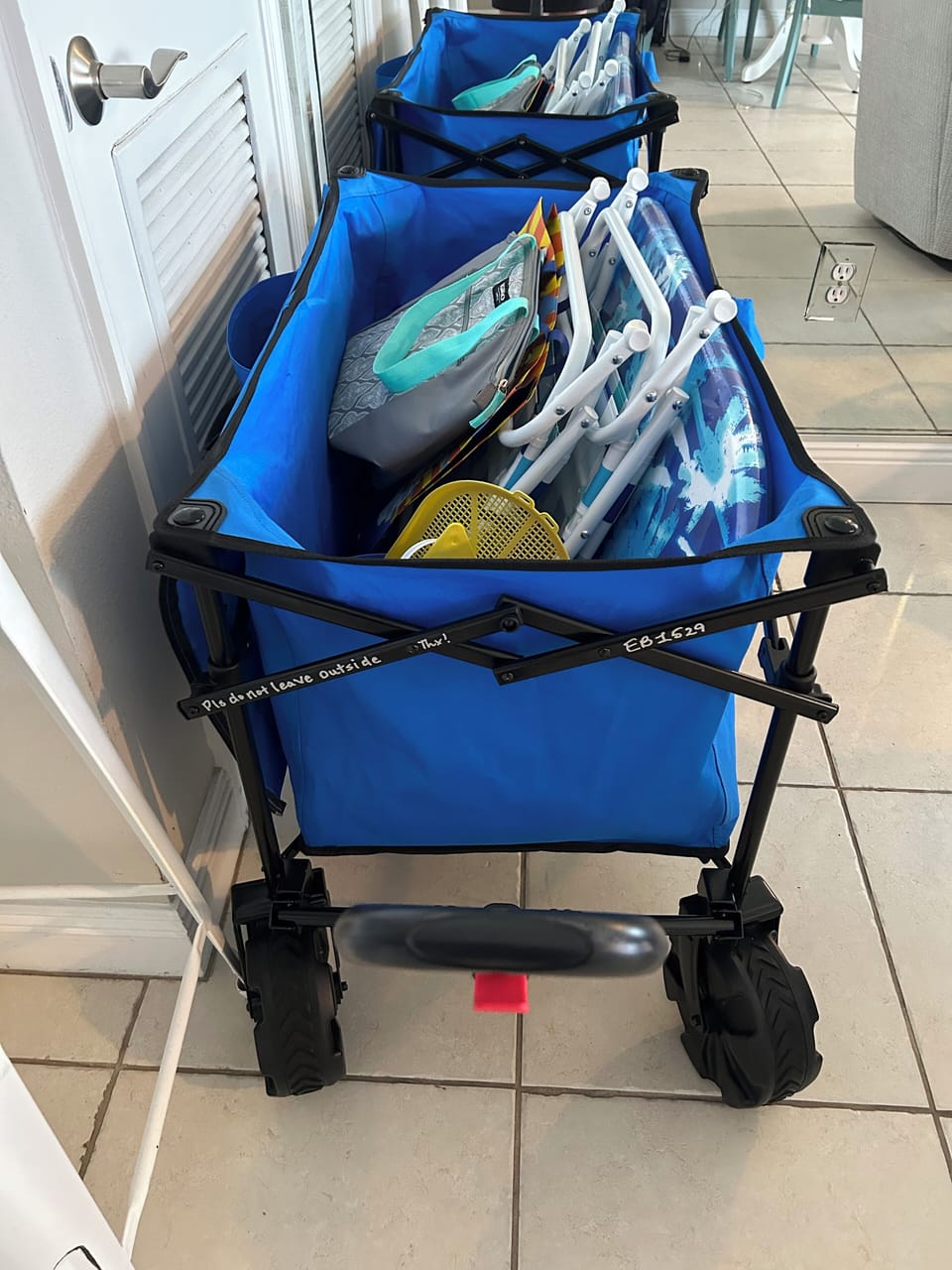 Wagon with toys, cooler and chairs.