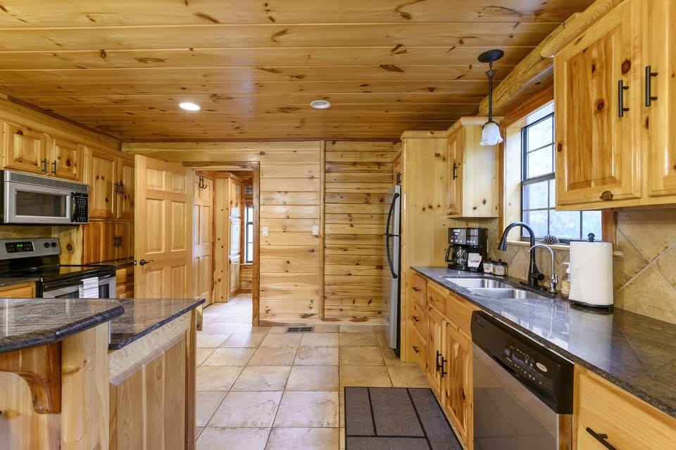 The fully stocked kitchen boasts modern appliances and ample counter space.